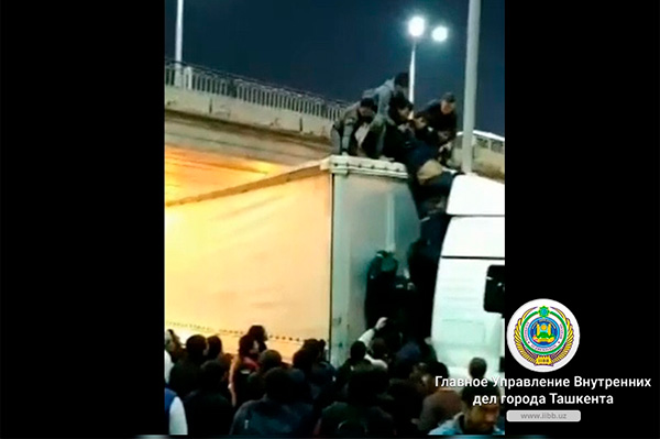 Drunk man hangs on the bridge near Kuylyuk market